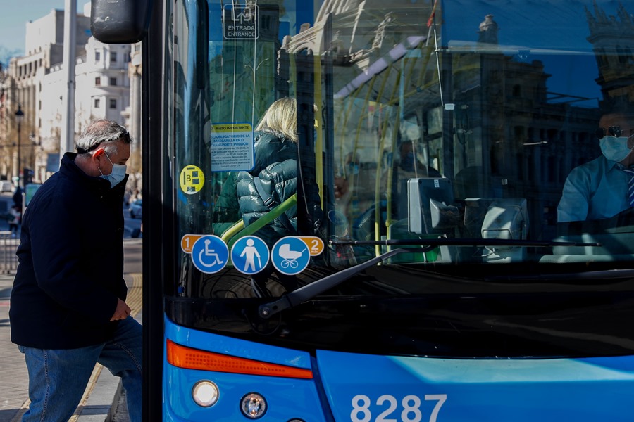 Un home puja a un bus en una foto d'arxiu.